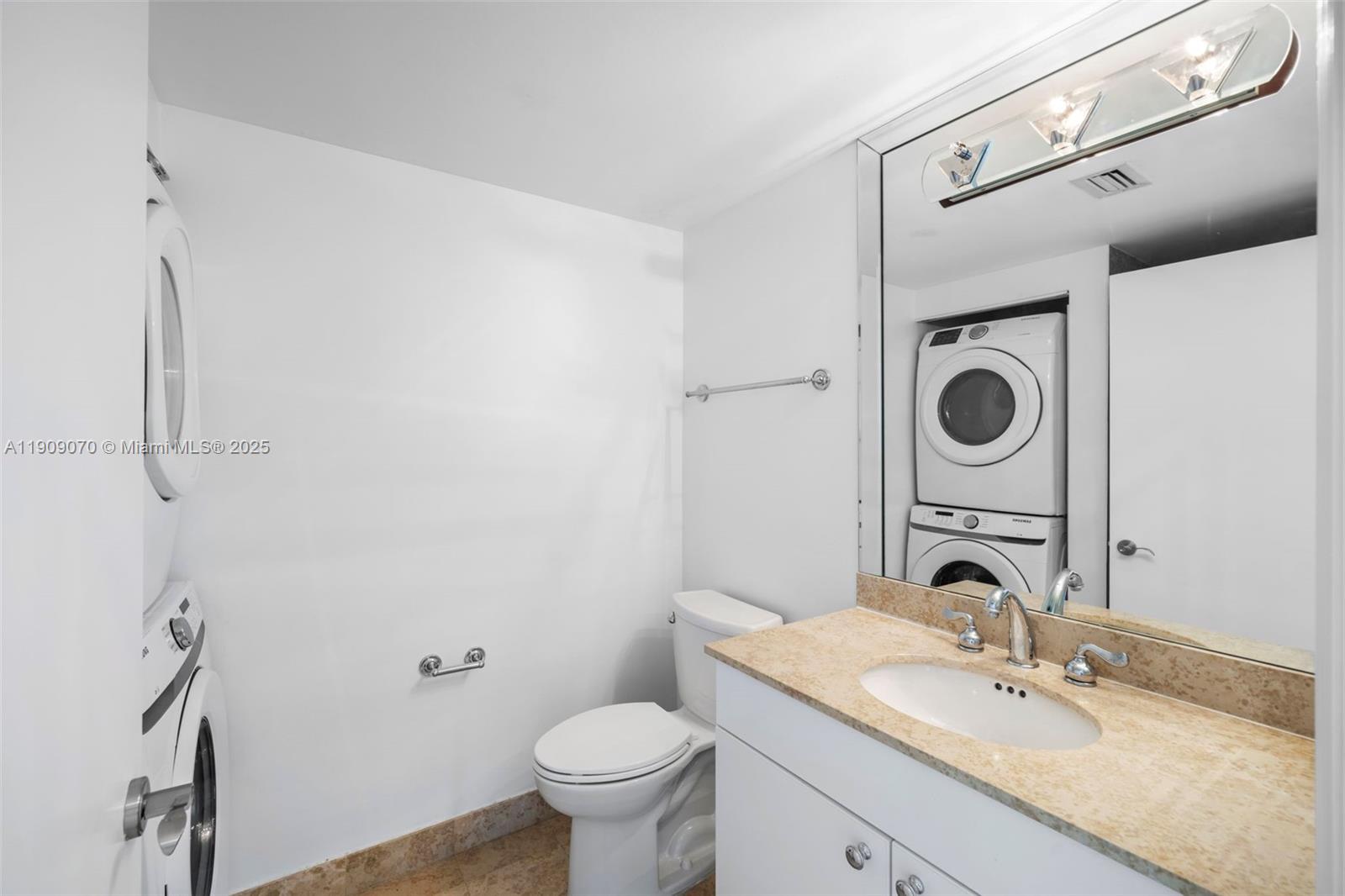 4775 Collins Avenue, Unit 1903 Miami Beach, FL 33140 - Photo 22 of 49 a bathroom with a sink toilet and a mirror