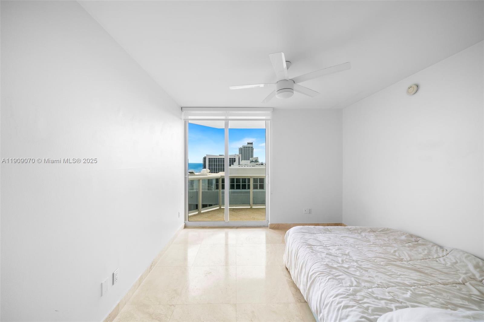 4775 Collins Avenue, Unit 1903 Miami Beach, FL 33140 - Photo 23 of 49 a bedroom with a bed and a window