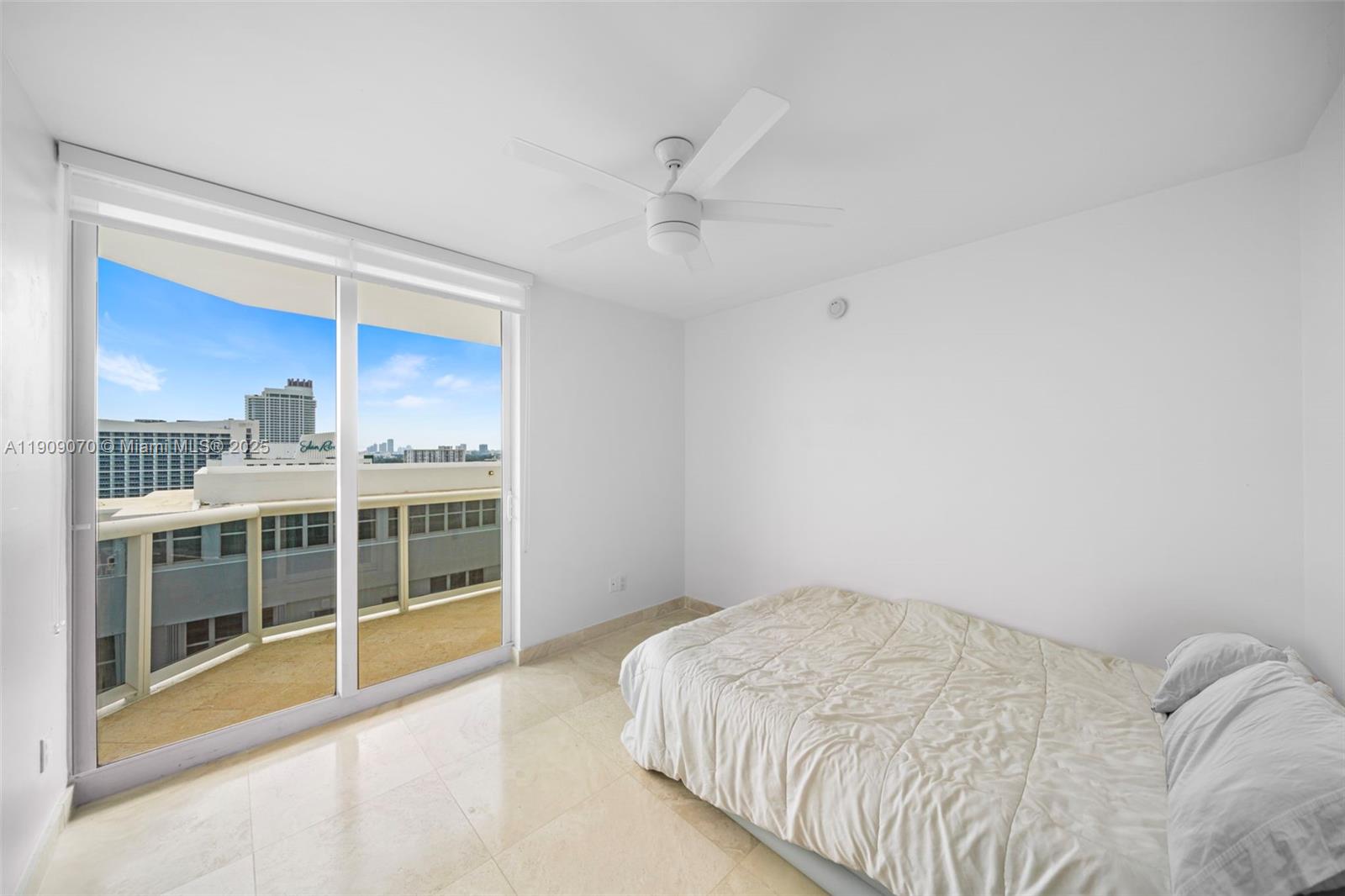 4775 Collins Avenue, Unit 1903 Miami Beach, FL 33140 - Photo 25 of 49 a bedroom with a large bed and a window