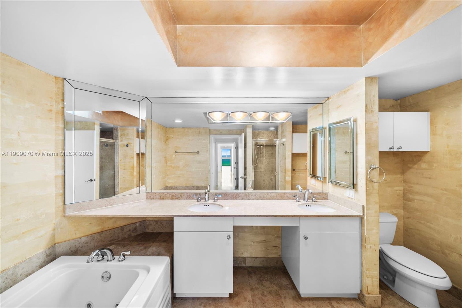 4775 Collins Avenue, Unit 1903 Miami Beach, FL 33140 - Photo 37 of 49 a bathroom with a double vanity sink mirror and toilet