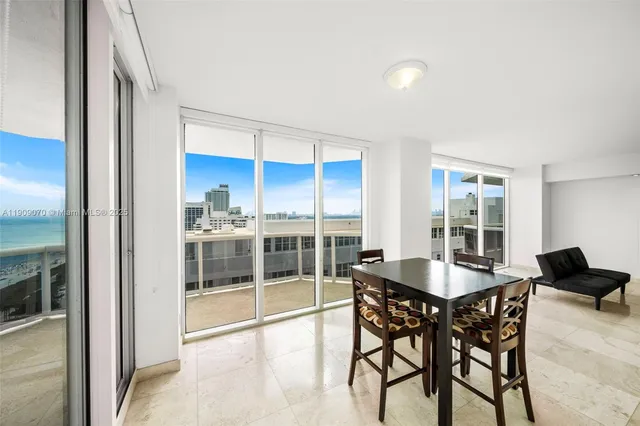 a view of an empty room with a chandelier fan