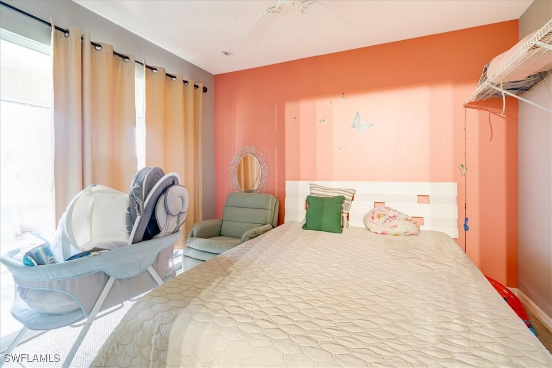 3980 Sunset Road Lehigh Acres, FL 33971 - Photo 15 of 42 a bedroom with bed and a window