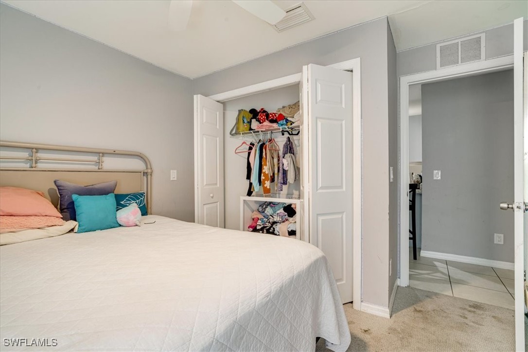 3980 Sunset Road Lehigh Acres, FL 33971 - Photo 17 of 42 a bed room with a bed and a view of living room