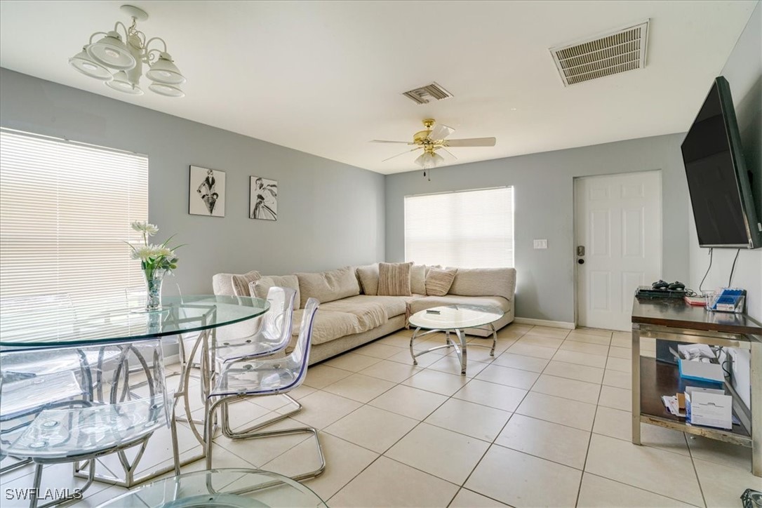 3980 Sunset Road Lehigh Acres, FL 33971 - Photo 18 of 42 a living room with furniture a flat screen tv and a window