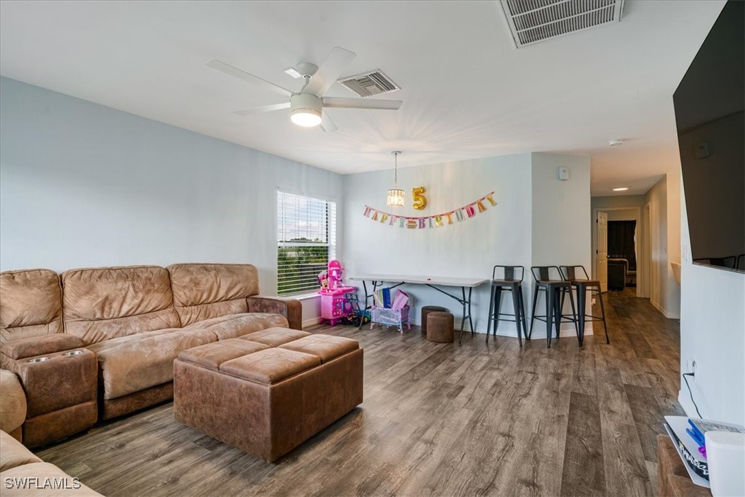 3980 Sunset Road Lehigh Acres, FL 33971 - Photo 2 of 42 a living room with furniture and a wooden floor
