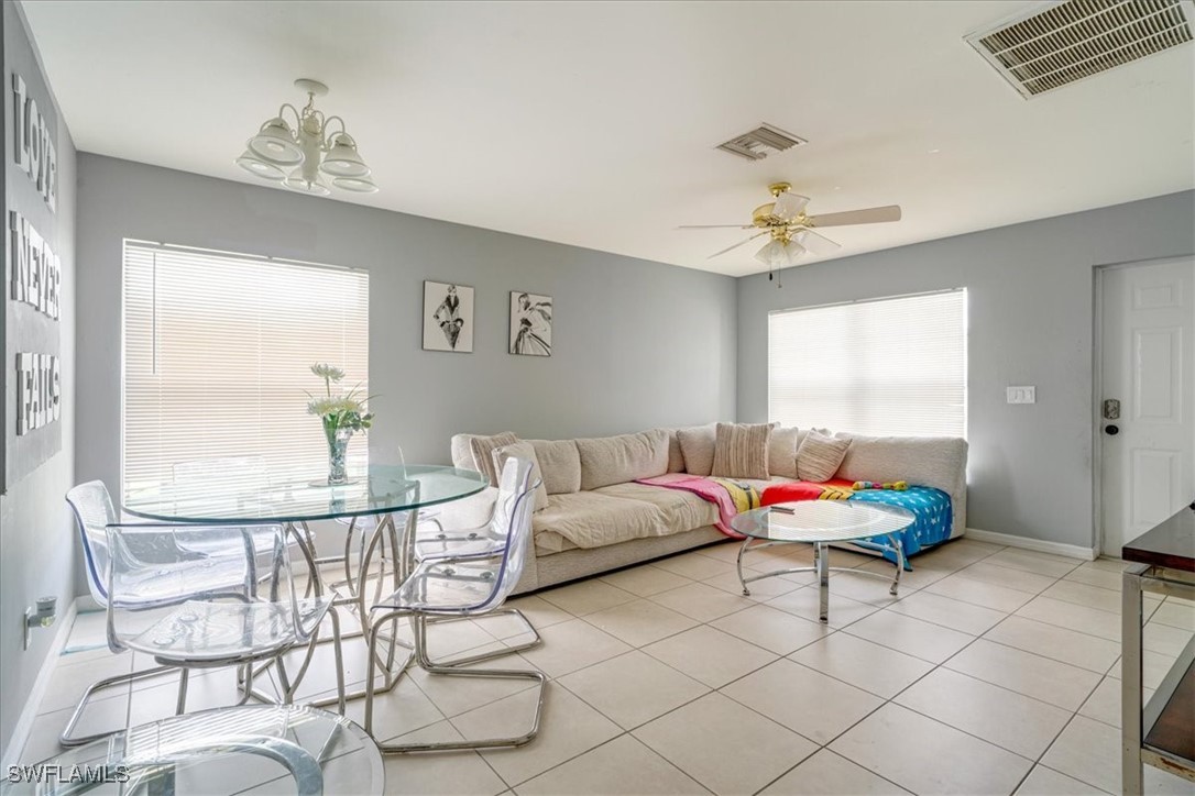 3980 Sunset Road Lehigh Acres, FL 33971 - Photo 26 of 42 a living room with furniture and a chandelier