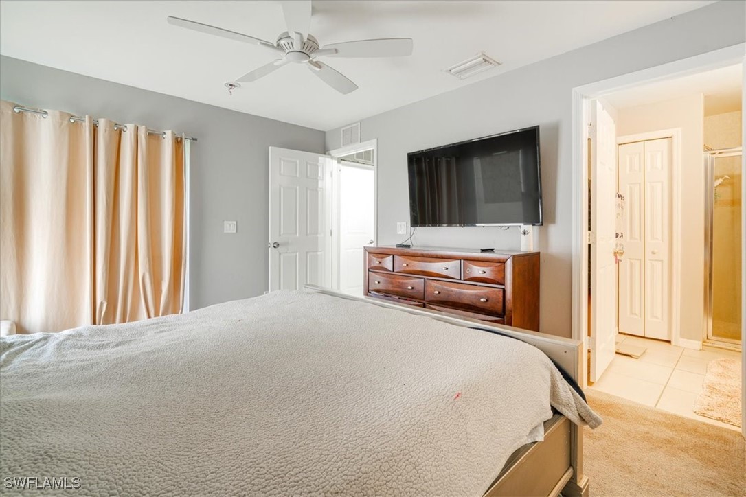 3980 Sunset Road Lehigh Acres, FL 33971 - Photo 29 of 42 a bedroom with a bed and a flat screen tv