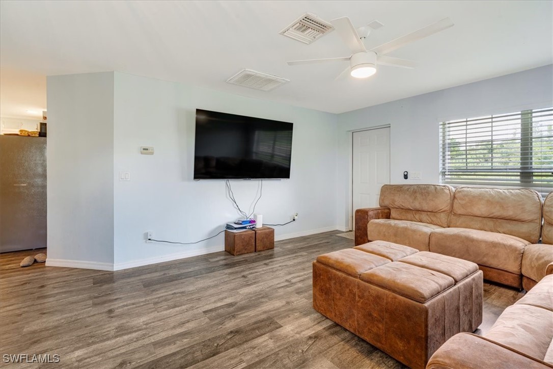 3980 Sunset Road Lehigh Acres, FL 33971 - Photo 3 of 42 a living room with furniture and a flat screen tv