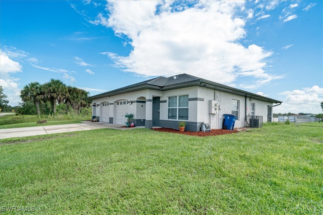 3980 Sunset Road Lehigh Acres, FL 33971 - Photo 33 of 42 a view of a house with a backyard
