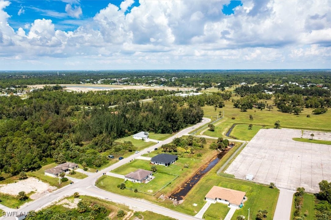 3980 Sunset Road Lehigh Acres, FL 33971 - Photo 39 of 42 an aerial view of residential houses with outdoor space