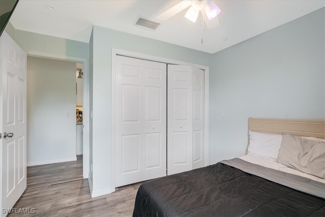 3980 Sunset Road Lehigh Acres, FL 33971 - Photo 8 of 42 a bedroom with a bed and a chandelier