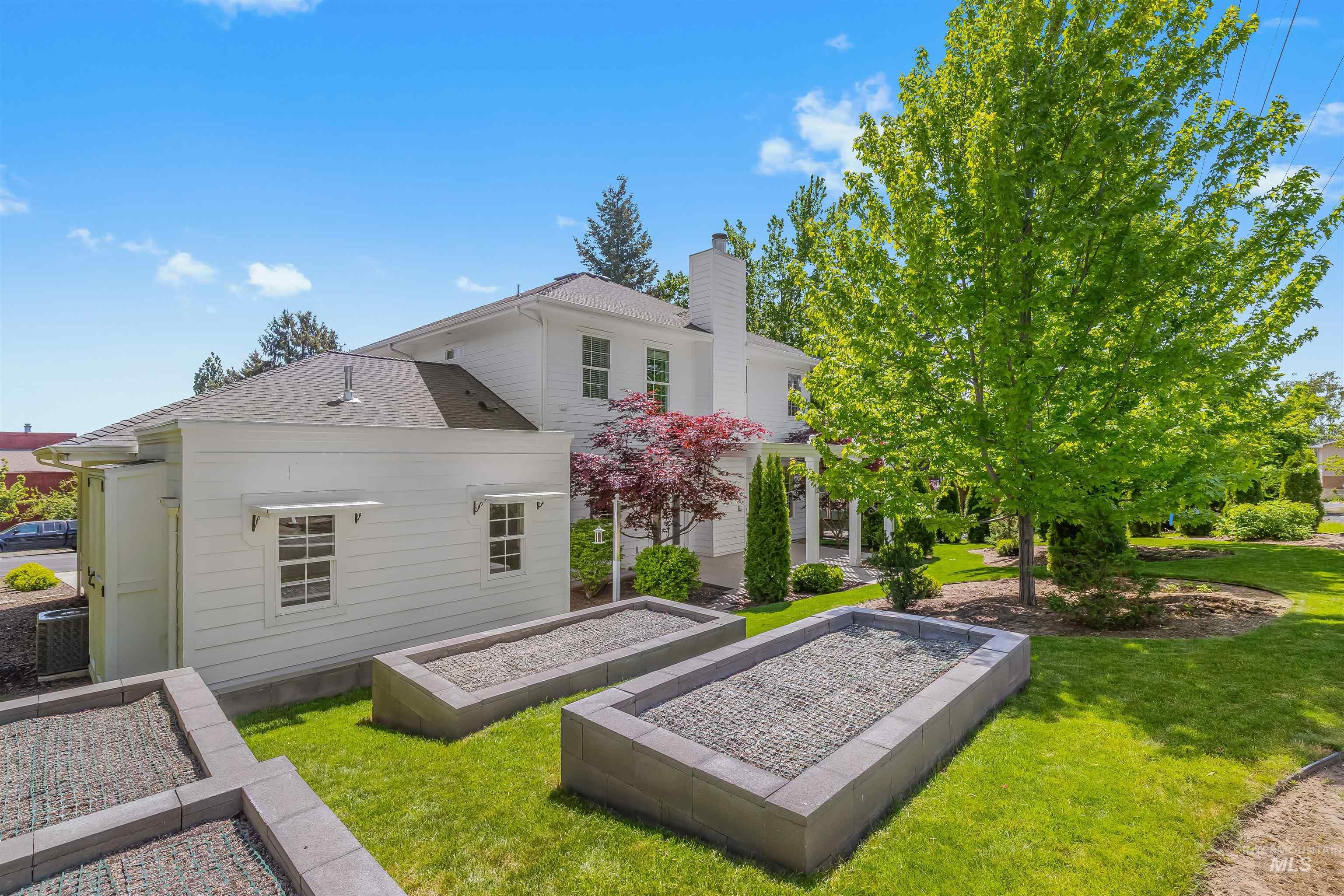 1617 Pine Cone Road Moscow, ID 83843 - Photo 32 of 44 Spacious rear yard featuring manicured lawn, established landscaping, and three raised garden beds