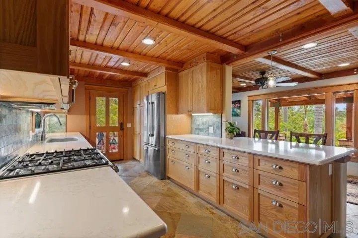 3097 Green Heather Lane Fallbrook, CA 92028 - Photo 12 of 37 a kitchen with sink stove and refrigerator