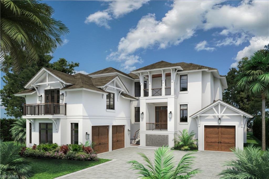 3277 Gordon Drive Naples, FL 34102 - Photo 1 of 28 a front view of a house with a garden