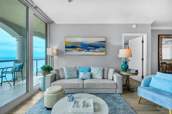 a living room with furniture and a potted plant