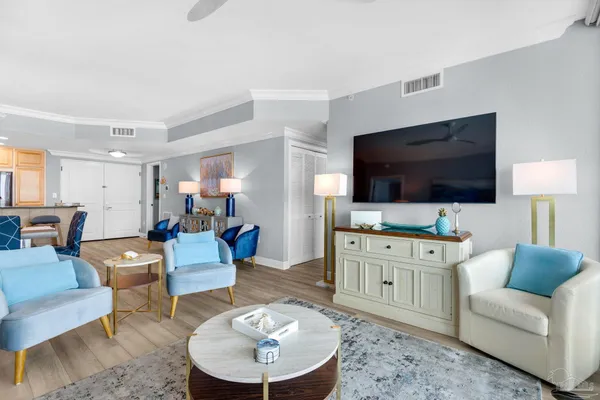 a living room with furniture and a flat screen tv