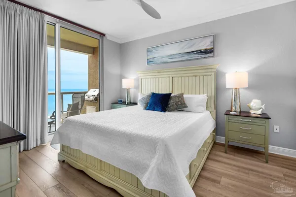 a bedroom with a bed and a large window