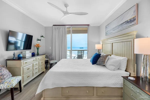 a bedroom with a large bed and a flat screen tv
