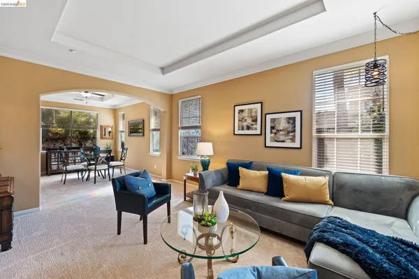 a living room with furniture and large windows