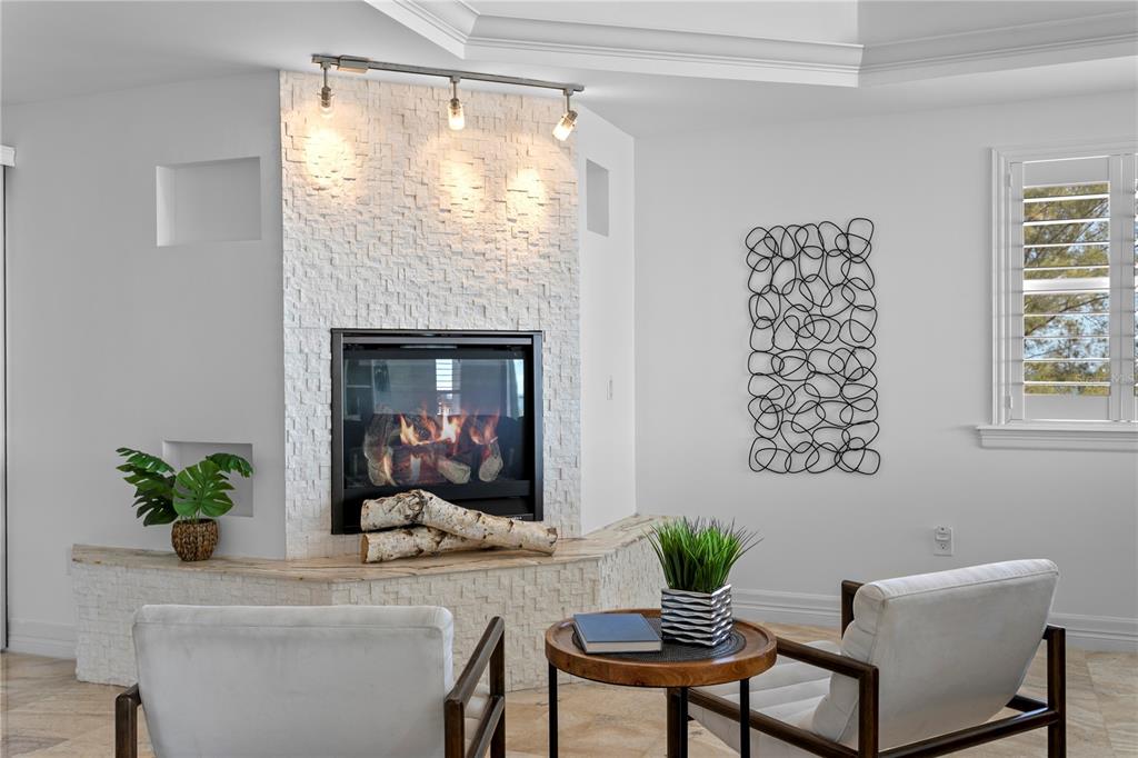 19730 Gulf Boulevard, Unit 400 Indian Rocks Beach, FL 33785 - Photo 23 of 90 a living room with furniture and a fireplace