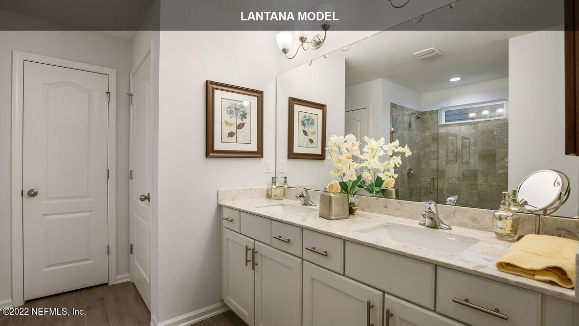 65696 Edgewater Drive Yulee, FL 32097 - Photo 10 of 44 a bathroom with a double vanity sink and mirror
