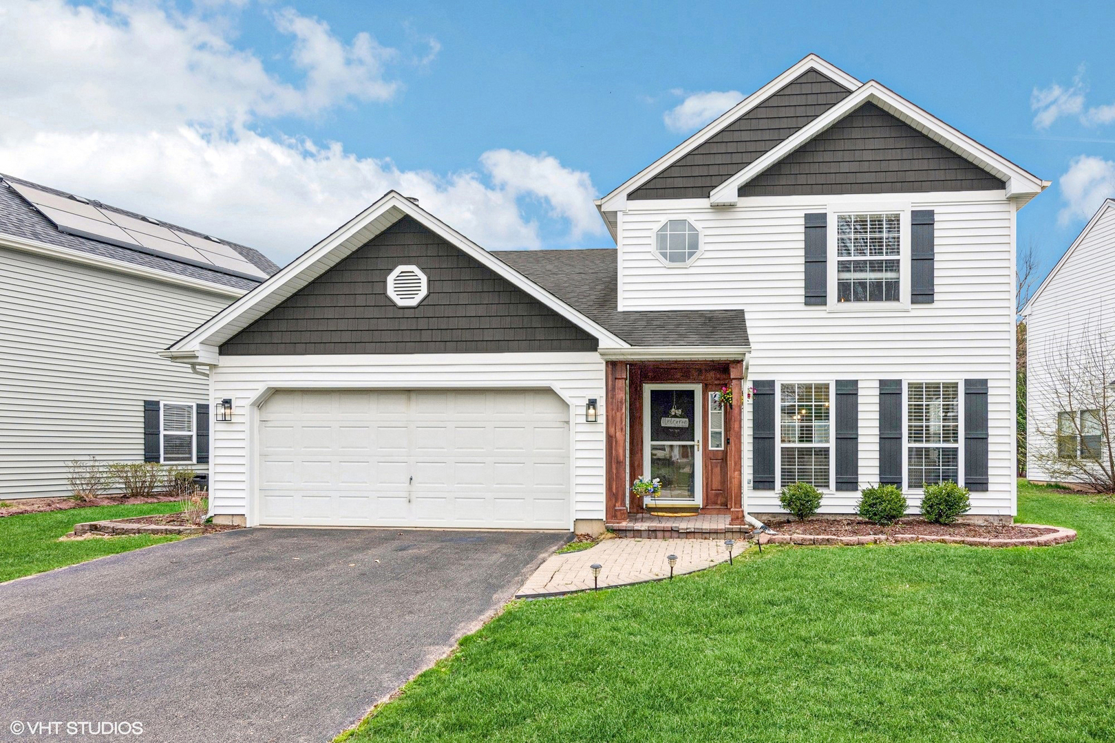 2421 Deerfield Drive Aurora, IL 60506 - Photo 1 of 22 a front view of a house with a yard and garage