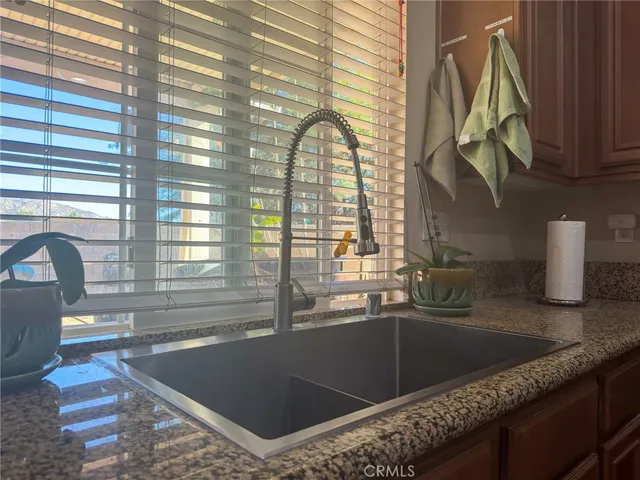 a kitchen with a sink a counter top space and cabinets