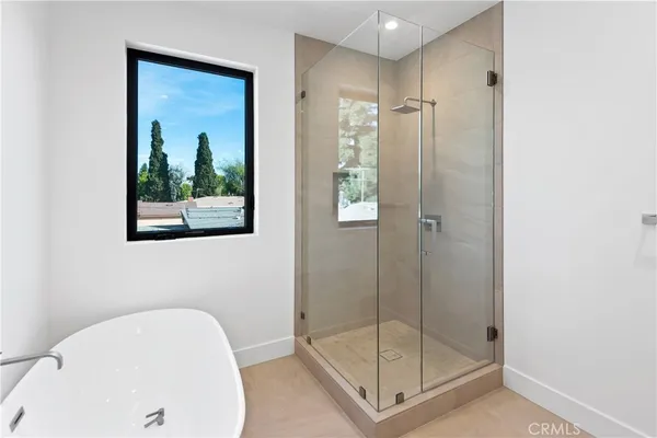 a bathroom with a shower and a sink