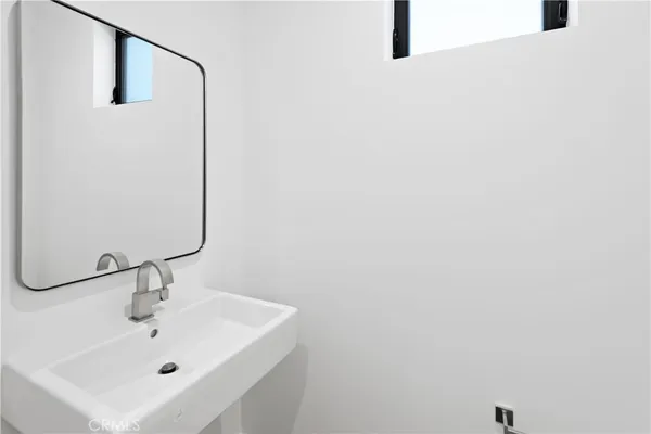 a bathroom with a sink and mirror
