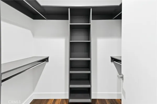 a view of walk in closet with empty racks