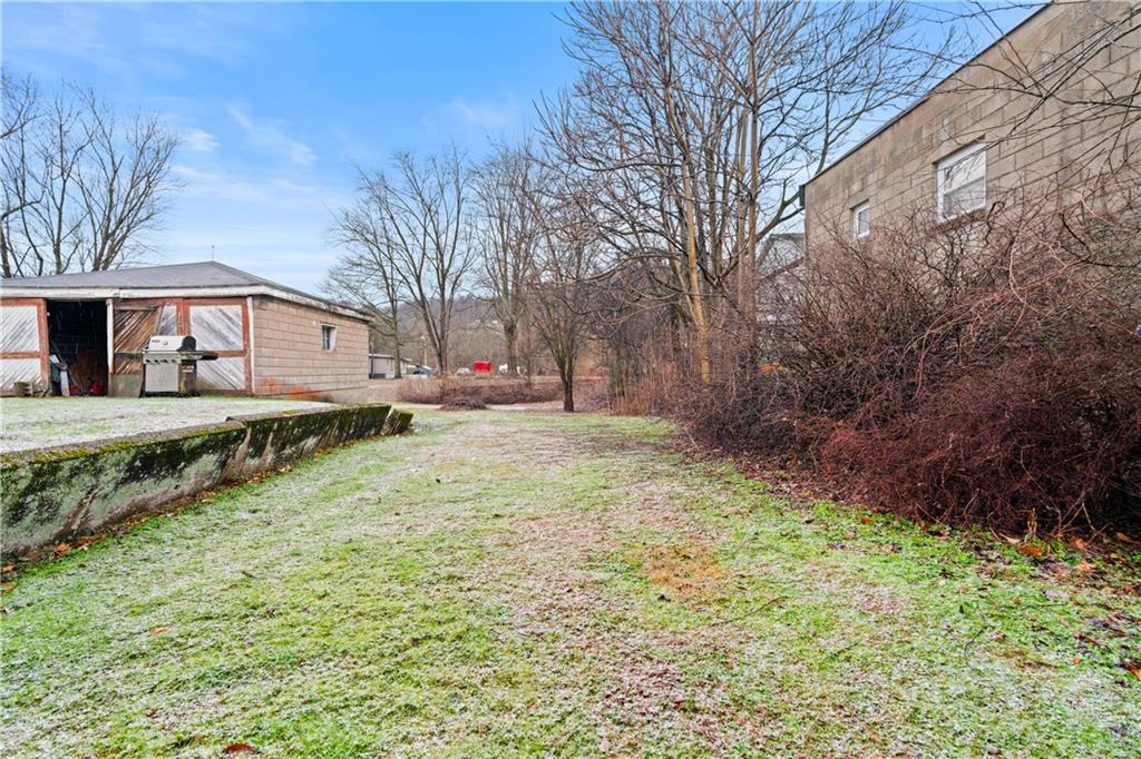 321 2nd Street Freeport, PA 16229 - Photo 23 of 24 a backyard of a house with large trees and outdoor seating