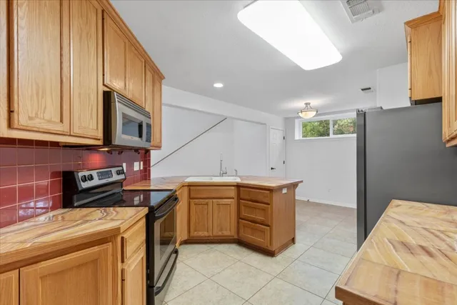 a kitchen with stainless steel appliances granite countertop a sink and cabinets