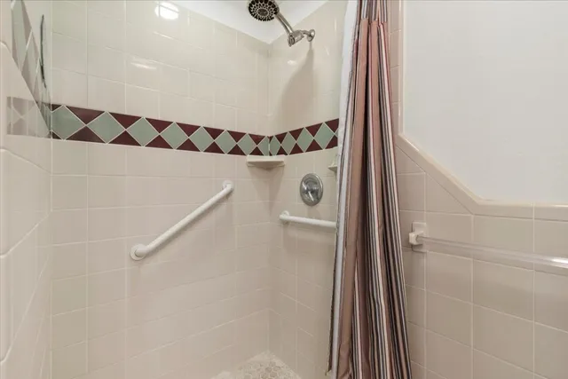 a bathroom with a shower and a mirror