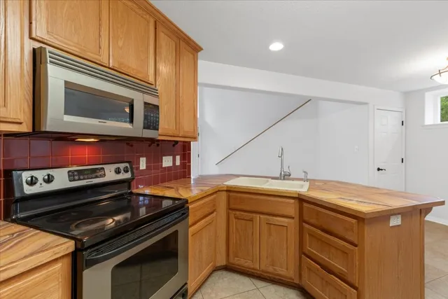 a kitchen with a sink stove and microwave