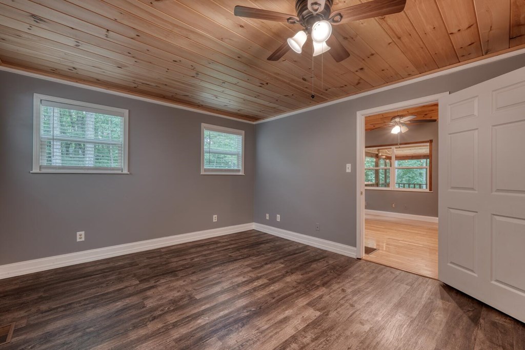 550 Watson Road Epworth, GA 30541 - Photo 26 of 63 an empty room with wooden floor and windows