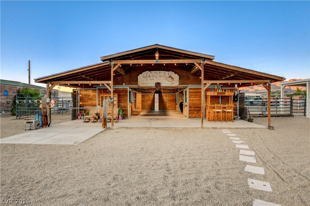 6460 Racel Street Las Vegas, NV 89131 - Photo 7 of 59 An expansive timber barn stands prominently against a clear blue desert sky.