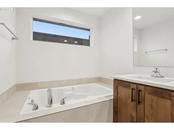 a bathroom with a bathtub and a sink