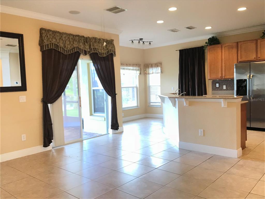 10505 Willow Ridge Loop Orlando, FL 32825 - Photo 11 of 45 a view of a kitchen with refrigerator and wooden floor
