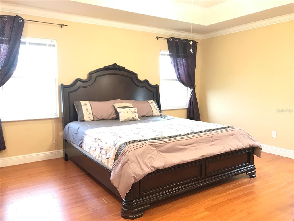 10505 Willow Ridge Loop Orlando, FL 32825 - Photo 24 of 45 a bedroom with a bed and a painting on the wall