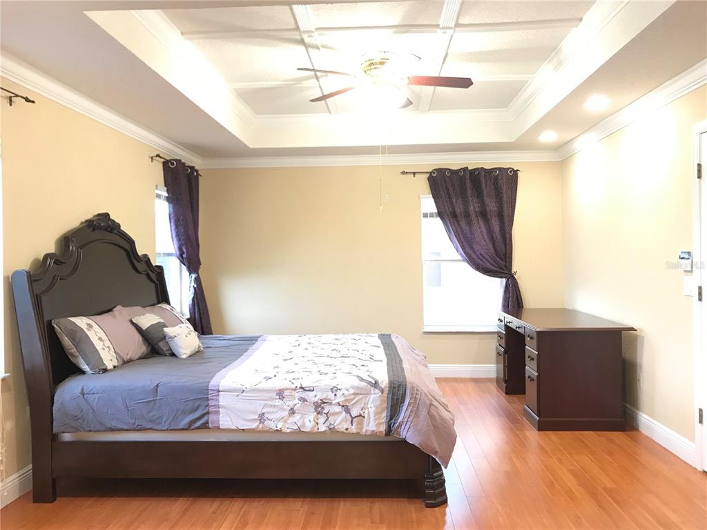 10505 Willow Ridge Loop Orlando, FL 32825 - Photo 25 of 45 a bedroom with a bed and wooden floor