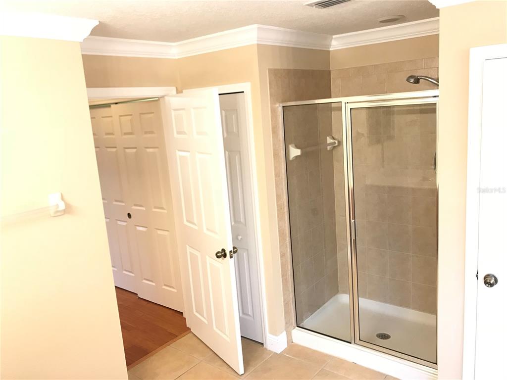10505 Willow Ridge Loop Orlando, FL 32825 - Photo 29 of 45 a bathroom with a glass shower door