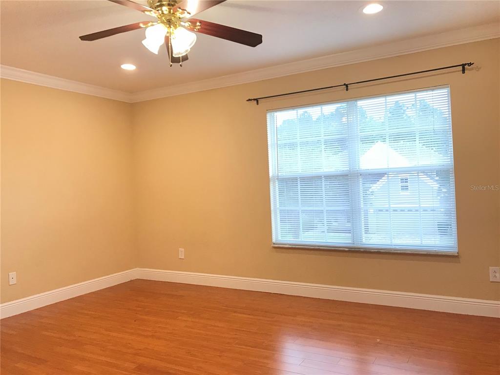 10505 Willow Ridge Loop Orlando, FL 32825 - Photo 30 of 45 an empty room with wooden floor and windows