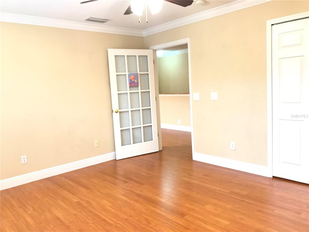 10505 Willow Ridge Loop Orlando, FL 32825 - Photo 31 of 45 a view of an empty room with wooden floor and a window