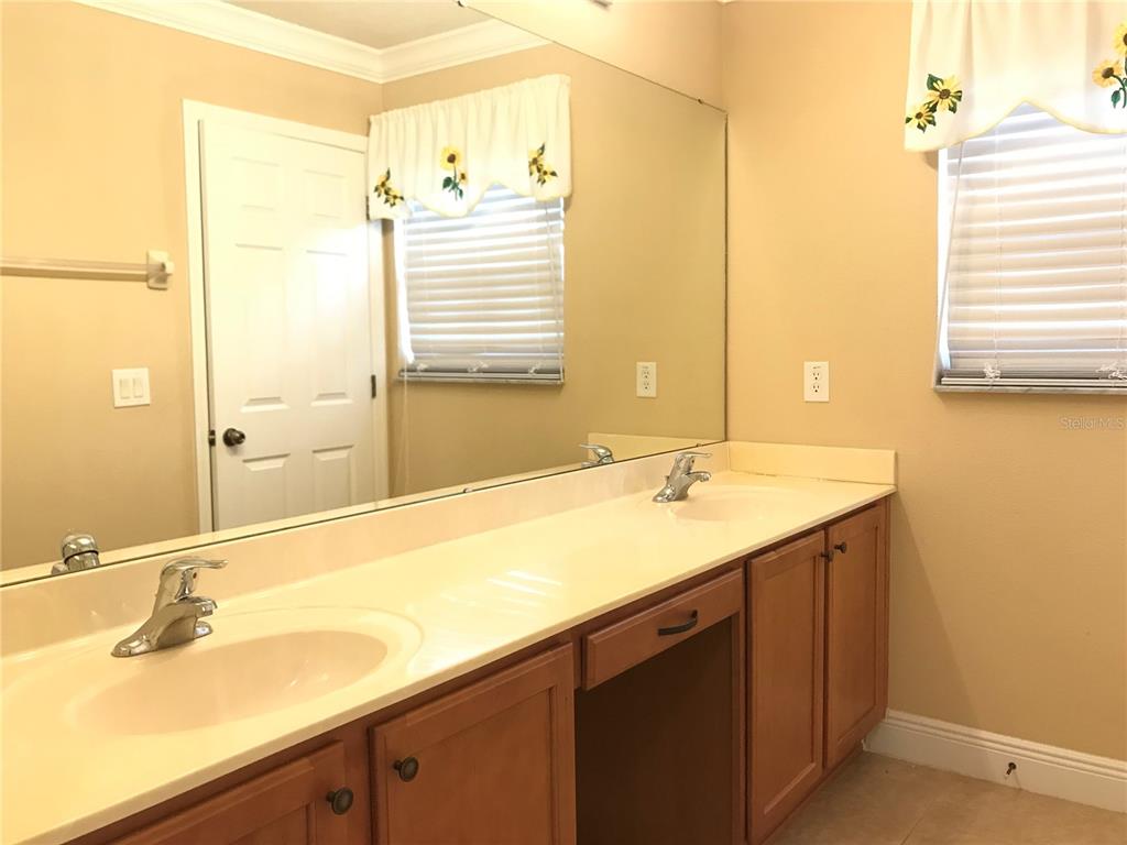 10505 Willow Ridge Loop Orlando, FL 32825 - Photo 33 of 45 a bathroom with a granite countertop sink and a mirror