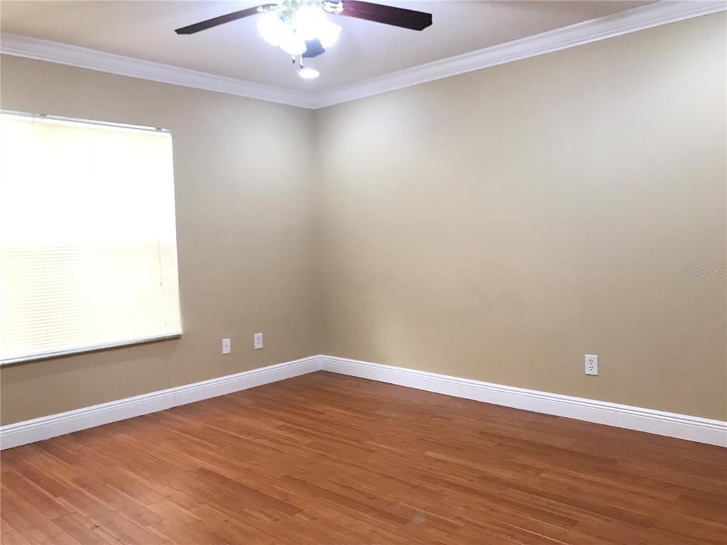 10505 Willow Ridge Loop Orlando, FL 32825 - Photo 37 of 45 an empty room with wooden floor and windows