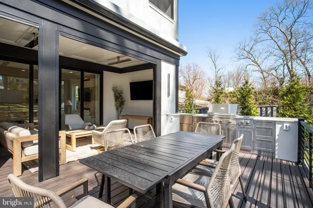 a living room with furniture tv and a large window