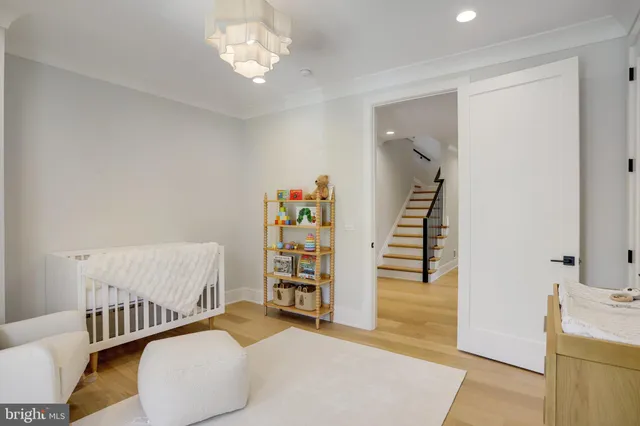 a kitchen with a sink and a stove with wooden floor