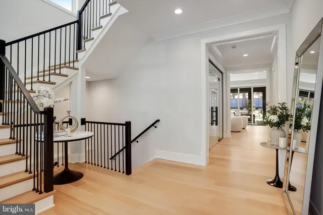 a large kitchen with kitchen island a stove a sink a oven and a dining table with wooden floor