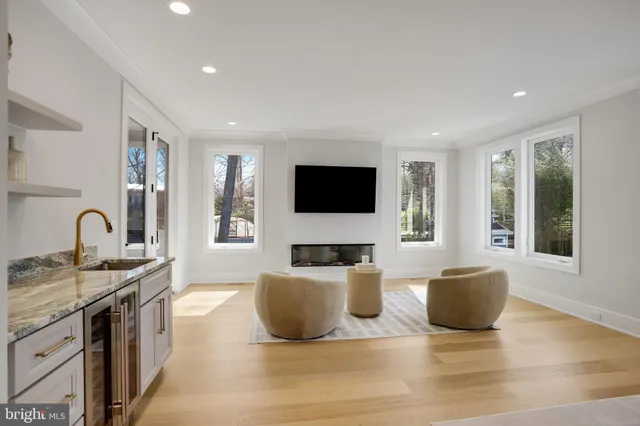 a living room with couches and a flat screen tv