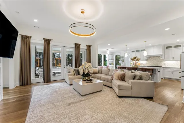 a large bedroom with a bed and a flat screen tv